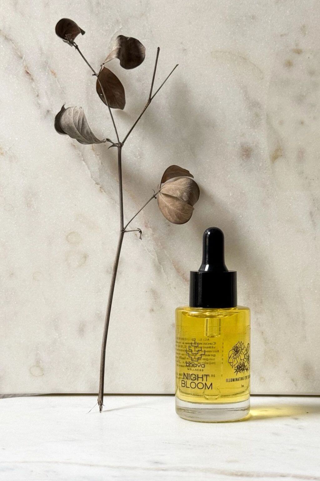 Night Bloom illuminating eye serum by Bhava Wellness on marble background