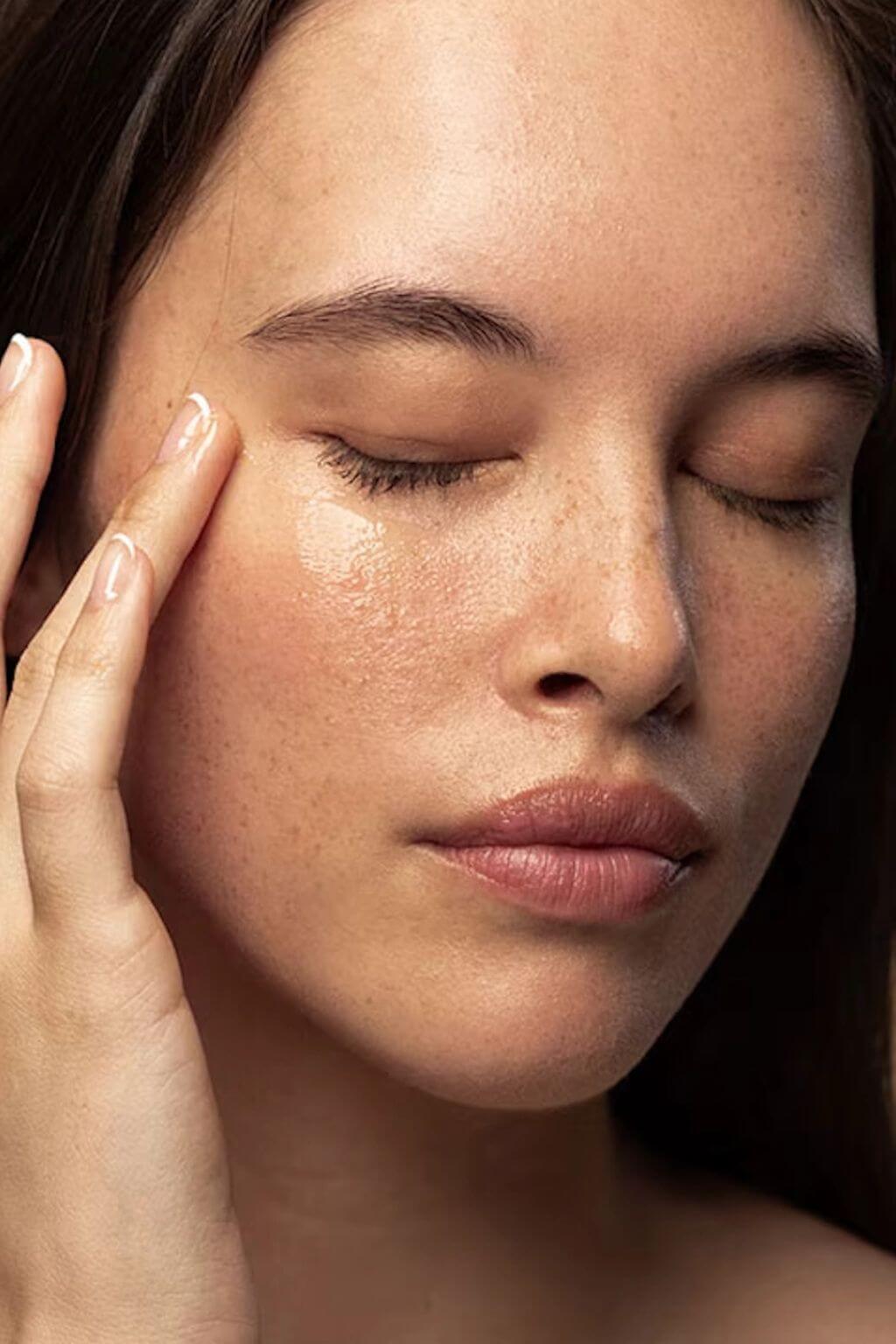 Natural botanical eye serum being applied under the eye for hydration and brightness