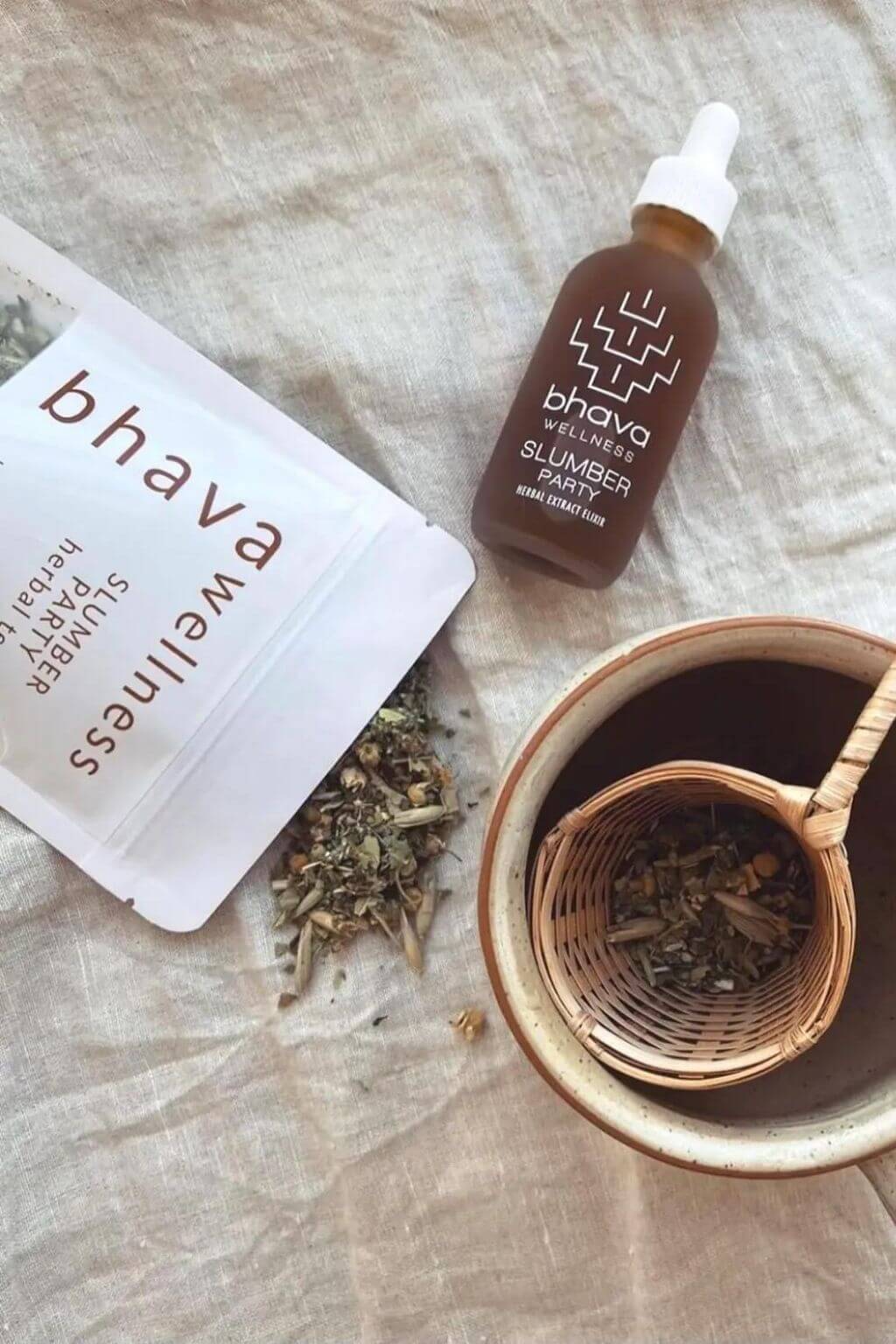 Bhava Wellness Slumber Party products with a tea cup and herbs on a textured surface