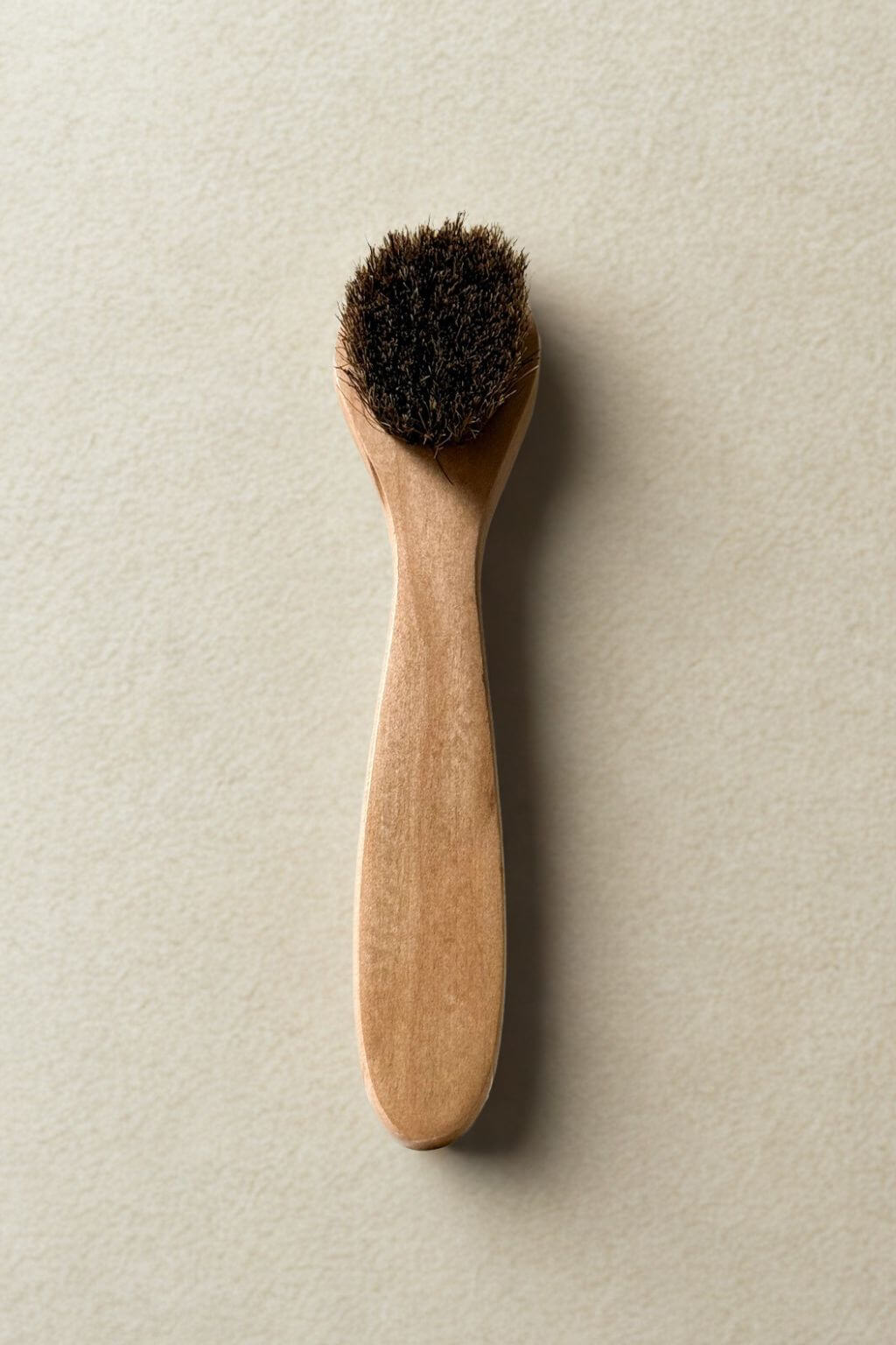 Soft eco-friendly face brush with wooden handle and natural bristles, front view