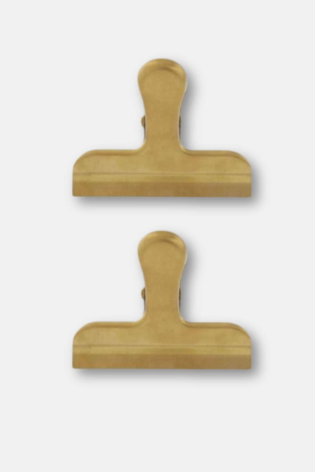Two gold metal clips shown vertically on a light gray background.