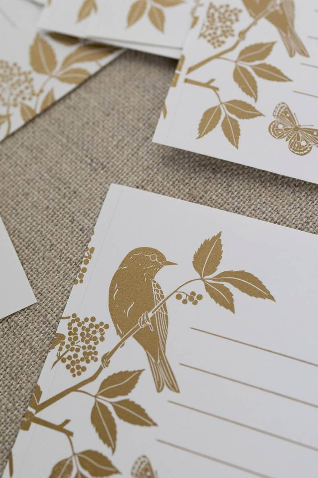 Meadow Gift Labels featuring golden illustrations of birds and wild botanicals on a textured surface.