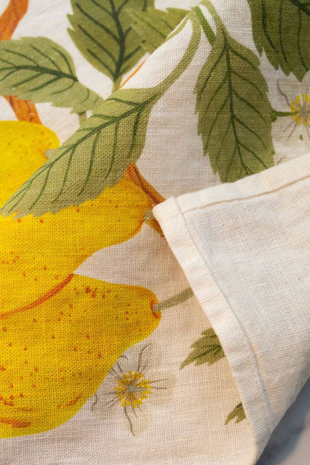Close-up of pear and blossom print on the Pear Orchard Linen Tea Towel.