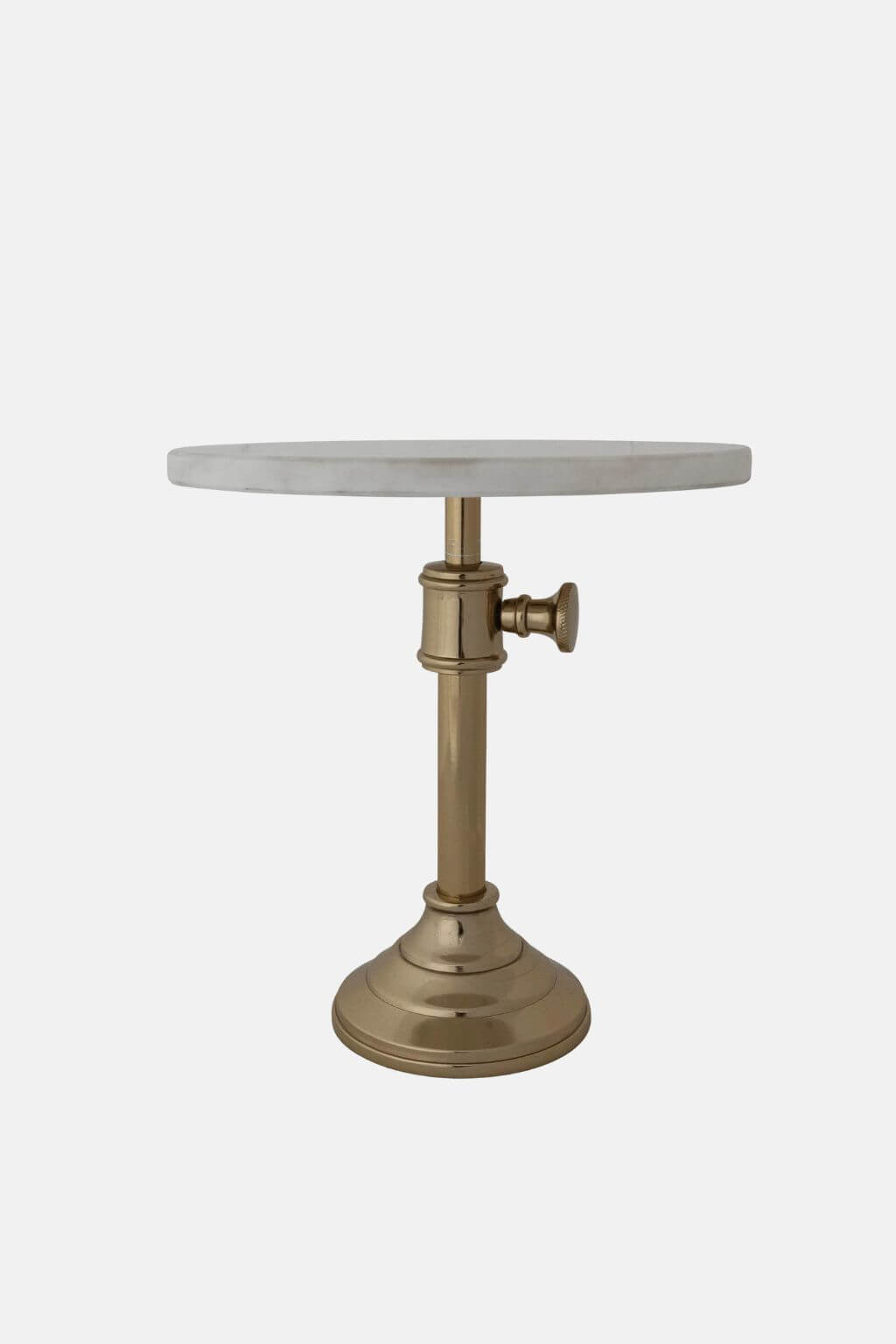 A modern pedestal side table featuring a round white marble top and a polished brass base with a side-mounted adjustment knob.