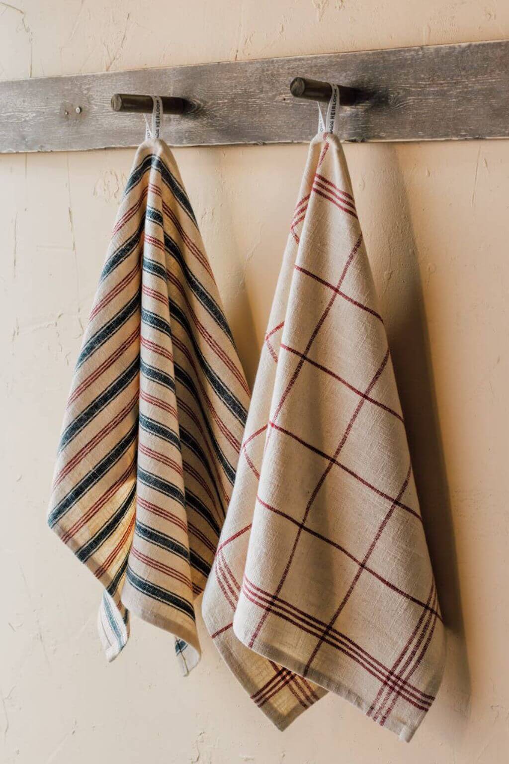 vintage french striped dish towels hanging on rustic kitchen hooks