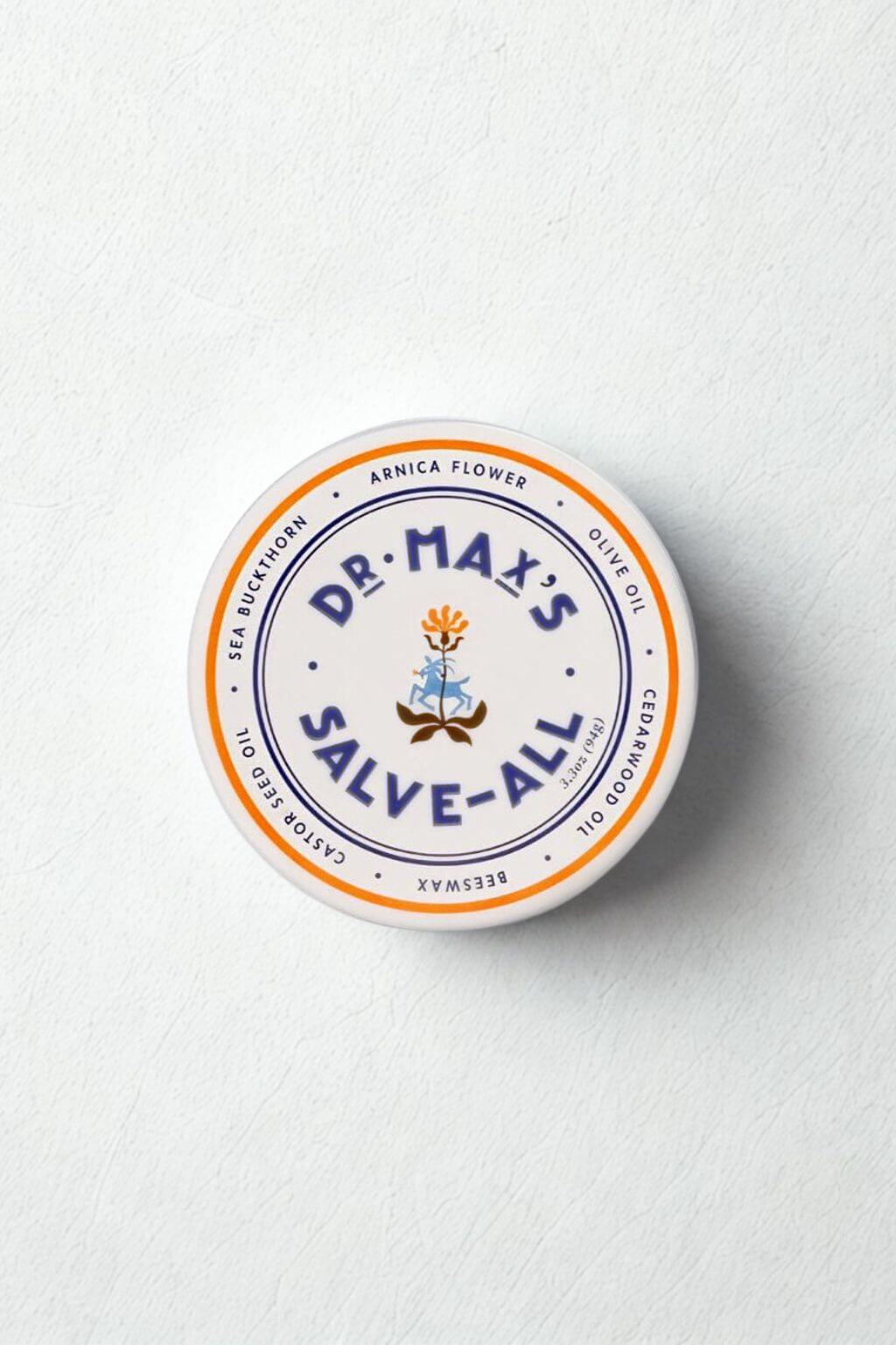 Tin of Salve-All styled on soft, textured background