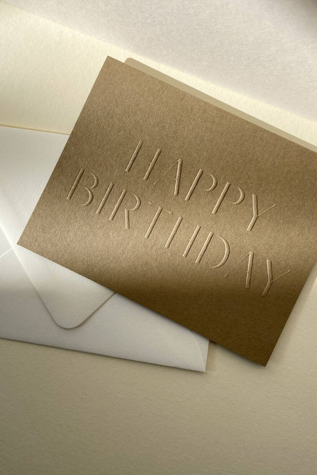 Angled view of embossed birthday card highlighting depth and paper texture