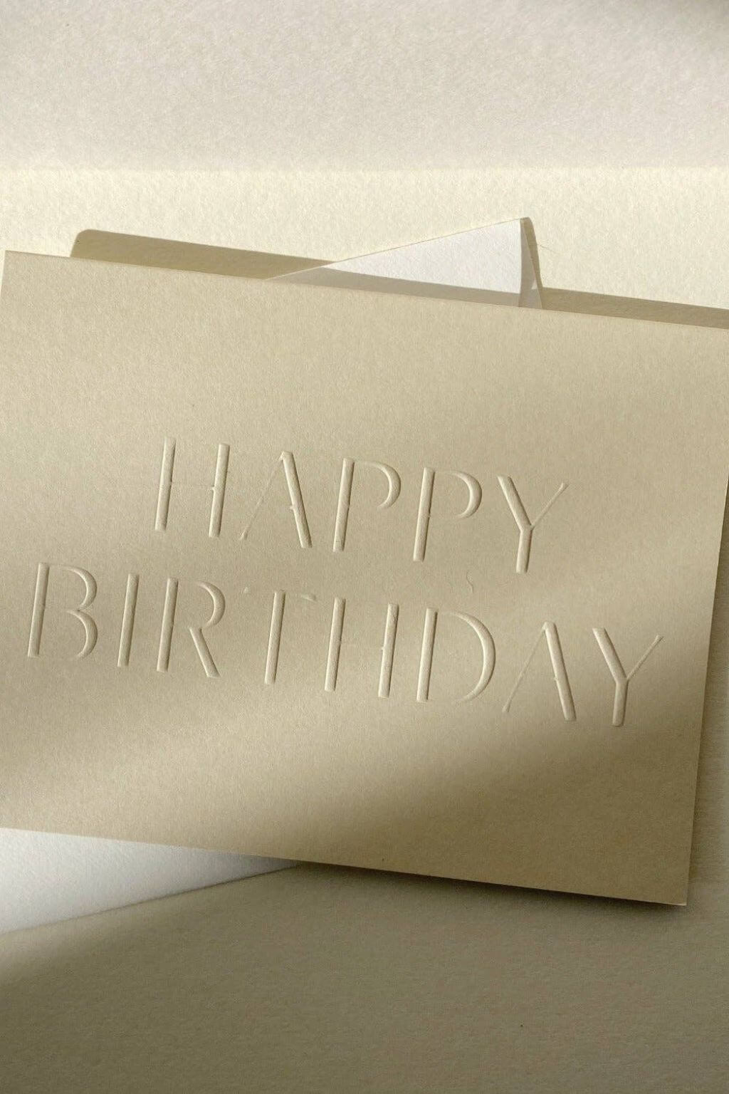 Neutral birthday card with envelope styled in warm natural light