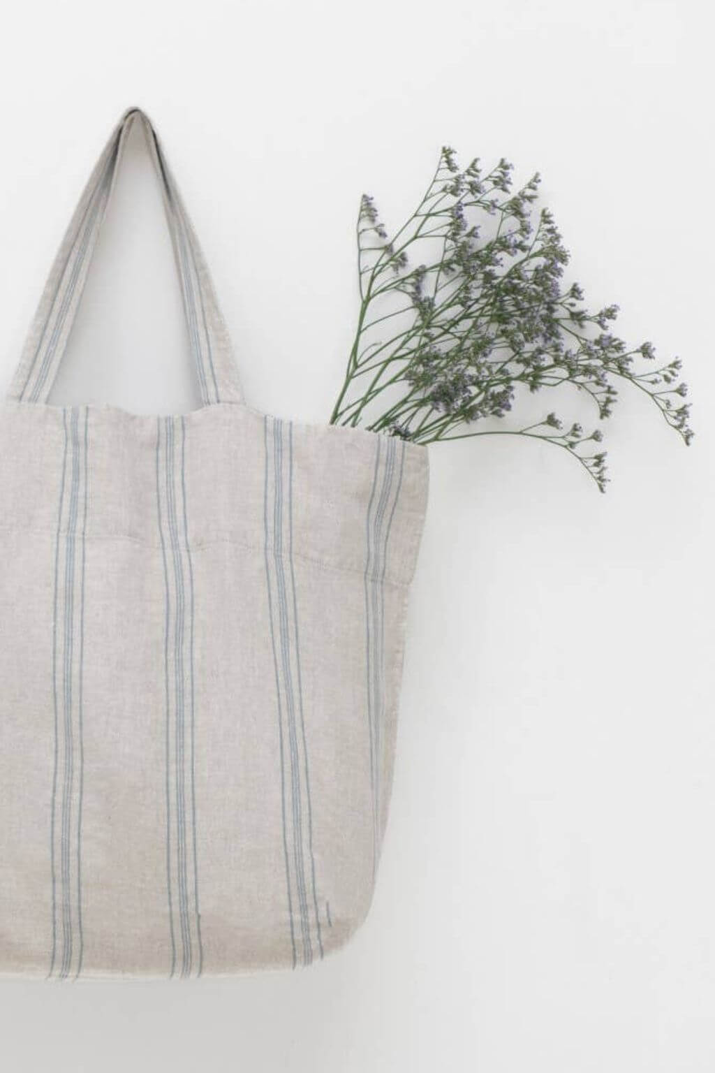 French stripe linen tote bag with fresh wildflowers tucked inside