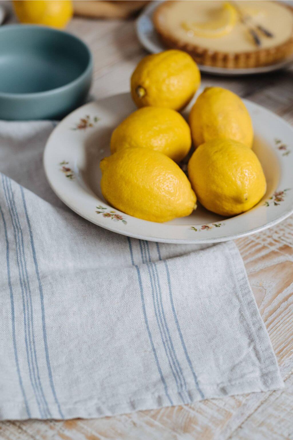 stonewashed linen kitchen towel soft textured stripe styled next to lemons