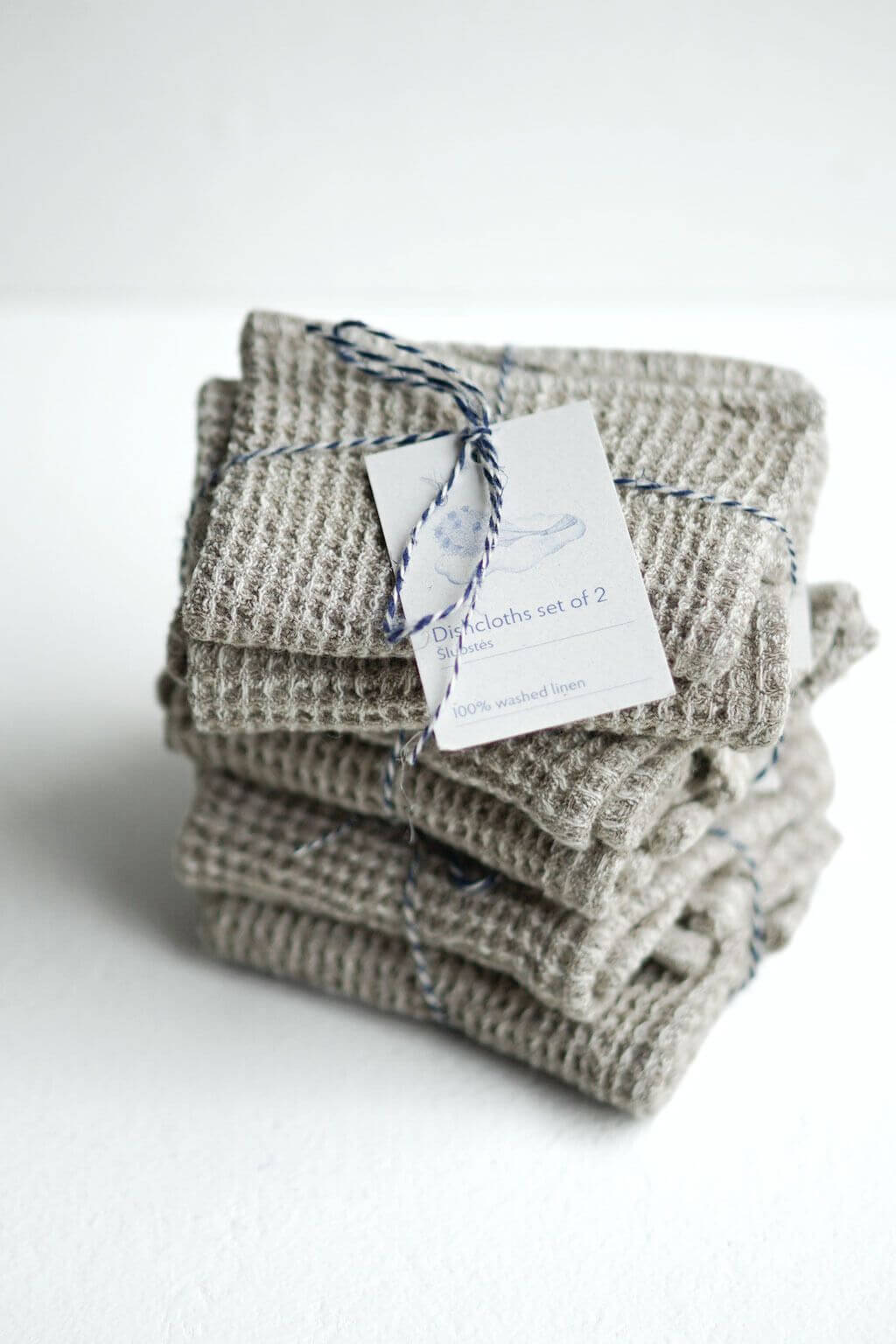 Natural linen waffle dishcloth set stacked and tied with artisan tag