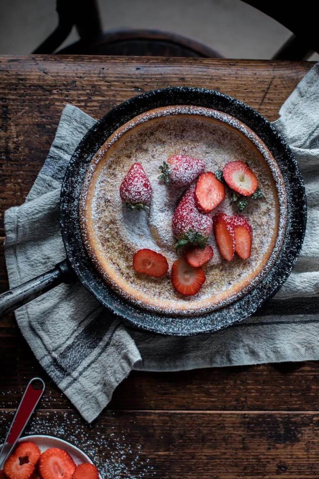 Blue stripe heritage linen towel styled beside rustic berry dessert