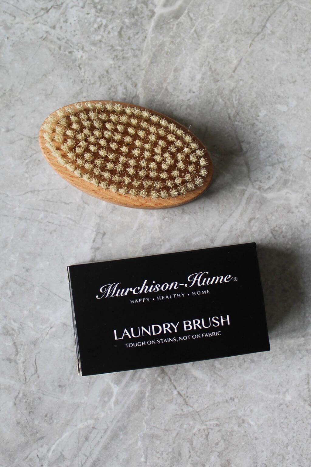 Laundry brush with packaging on a gray surface