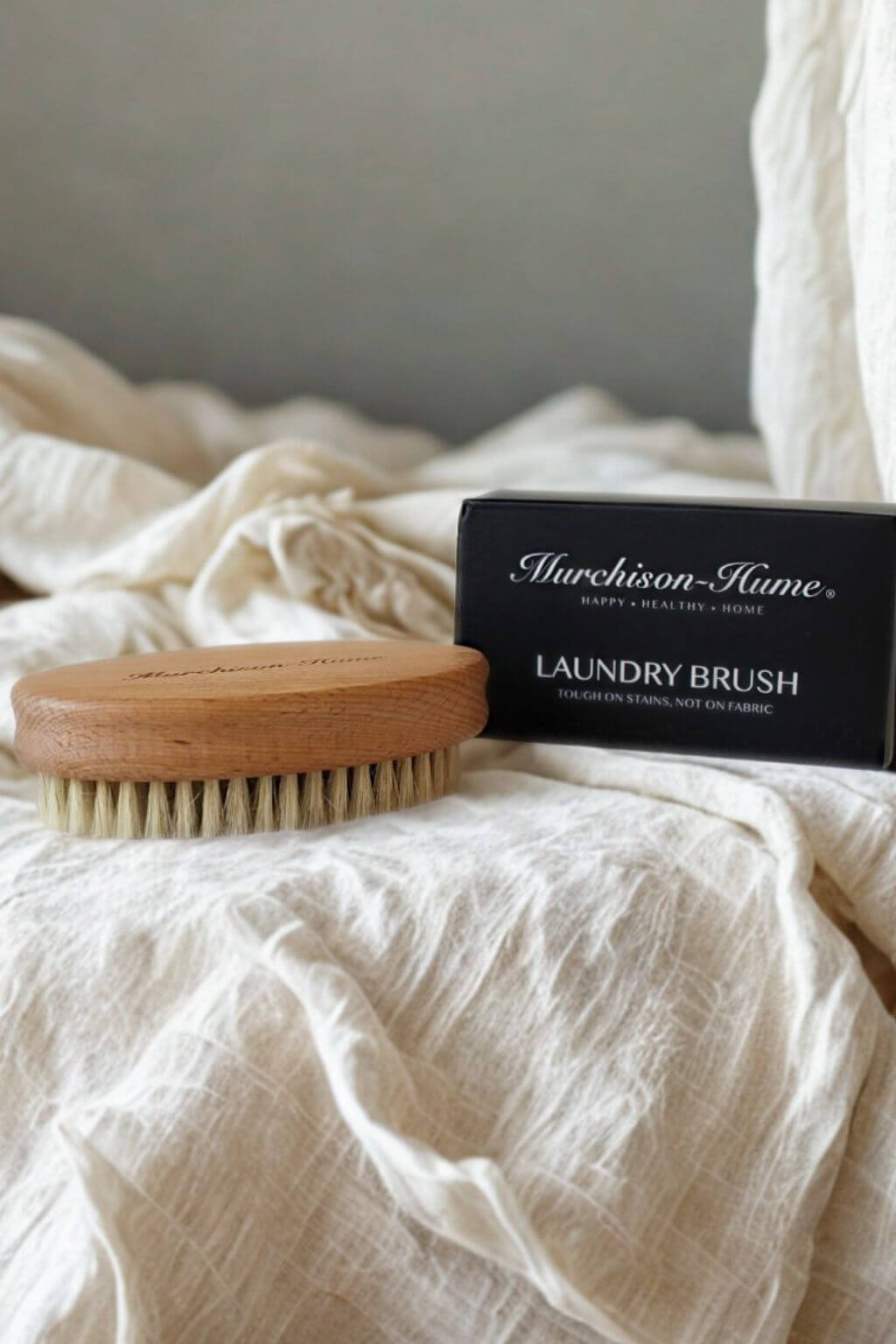 Laundry brush and packaging on a textured surface