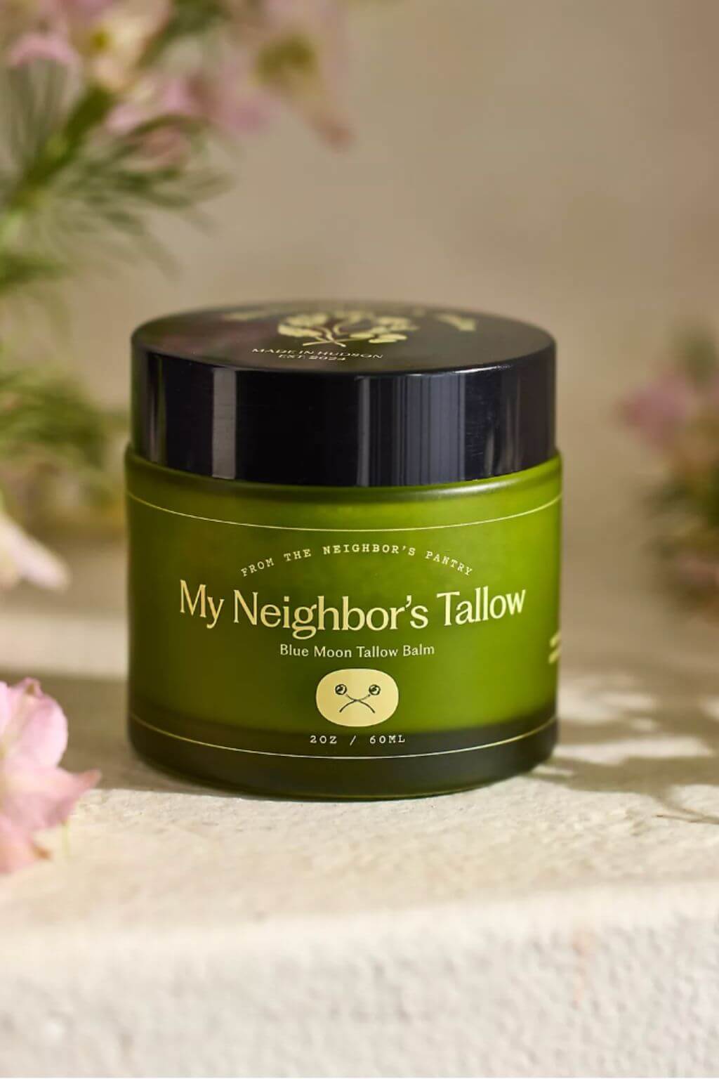 My Neighbor’s tallow balm jar styled with botanical background
