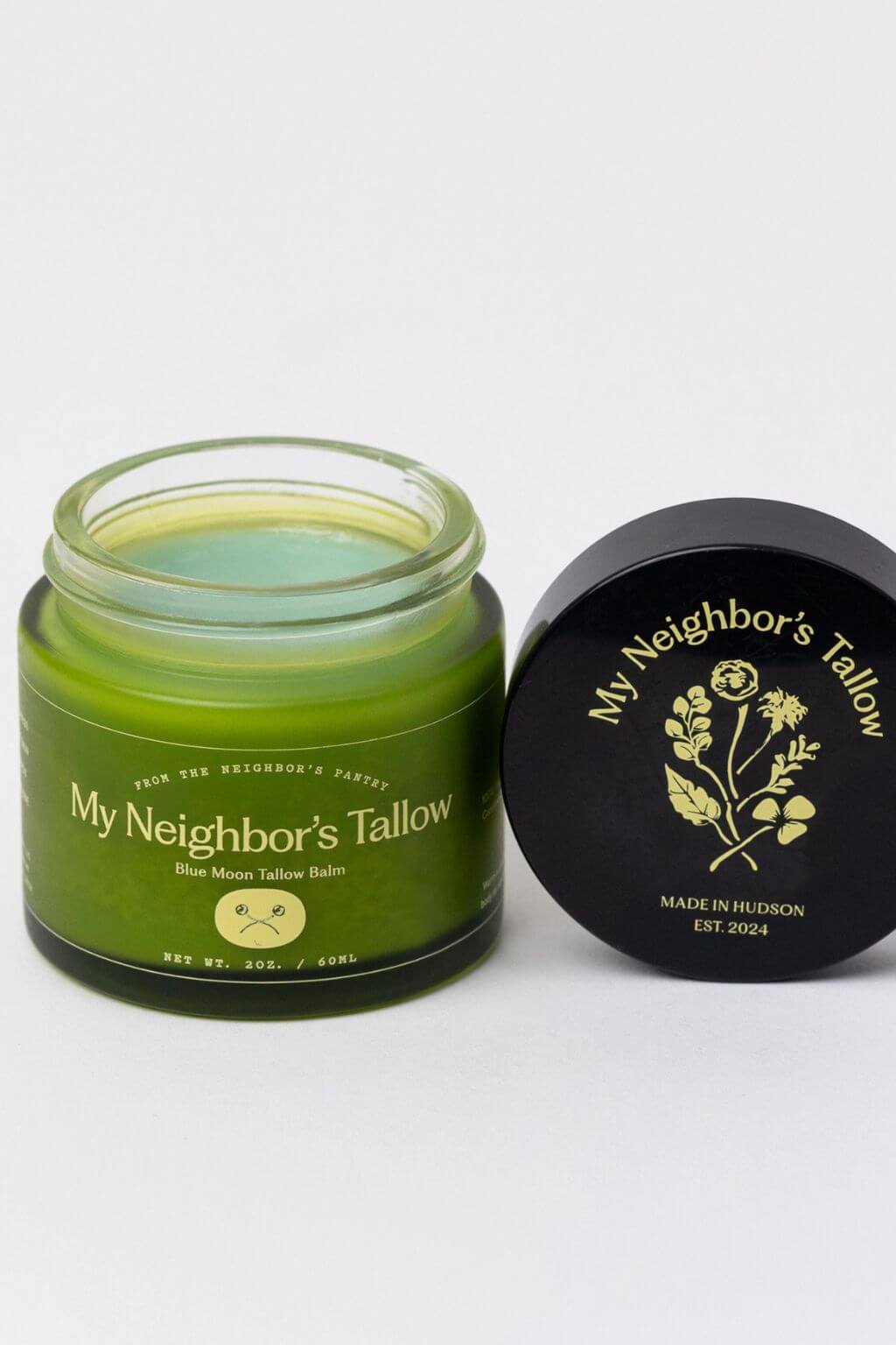 Blue Moon tallow balm jar with lid open showing green balm