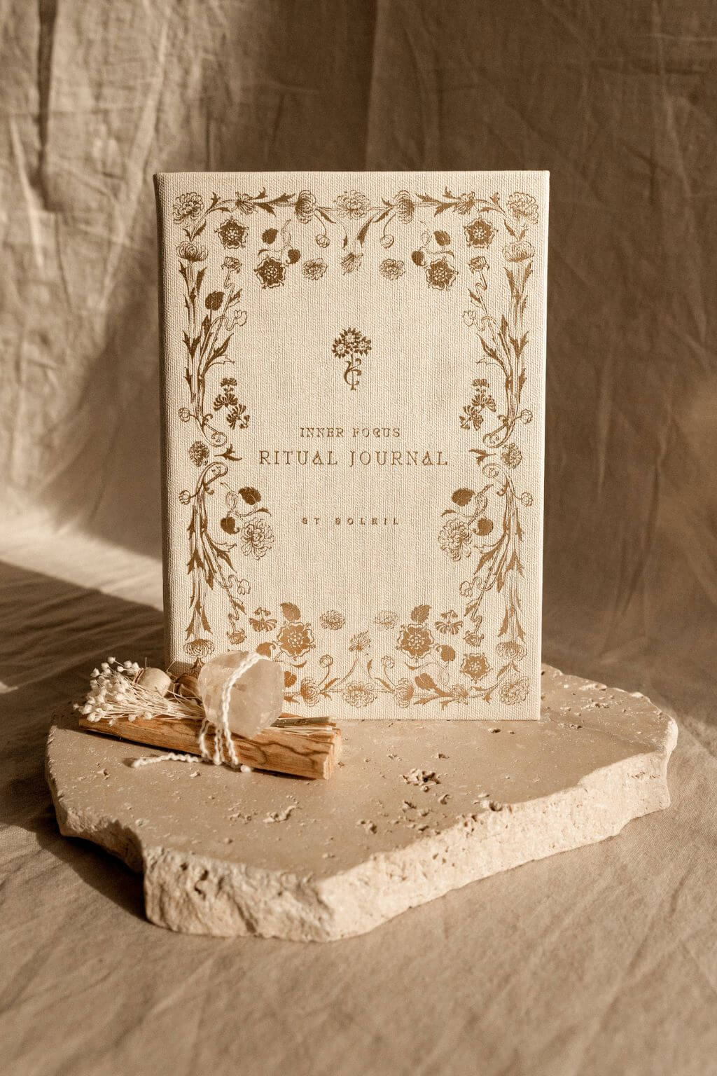 Decorative journal with floral design on a stone surface