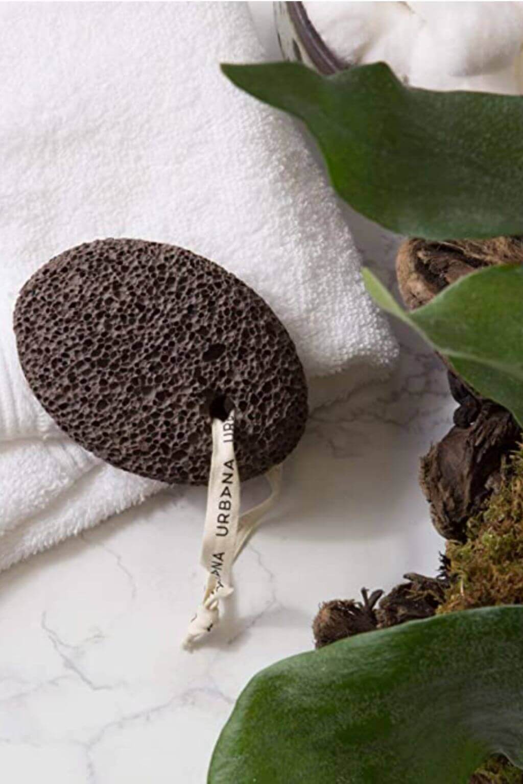 Close-up of natural lava stone pumice showcasing porous volcanic texture and attached cotton cord