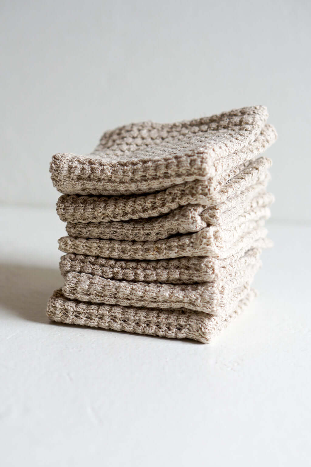 Stack of woven hemp washcloths with natural textured fiber