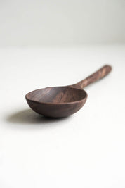 Hand-carved walnut wooden spoon with deep rounded bowl and smooth natural finish