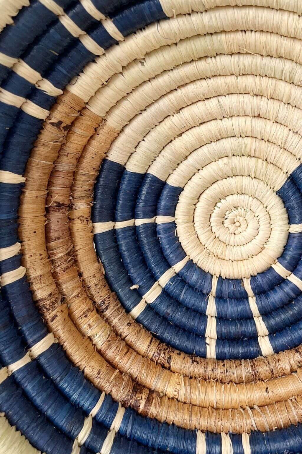 Close-up detail of handwoven raffia, banana bark, and sweetgrass basket