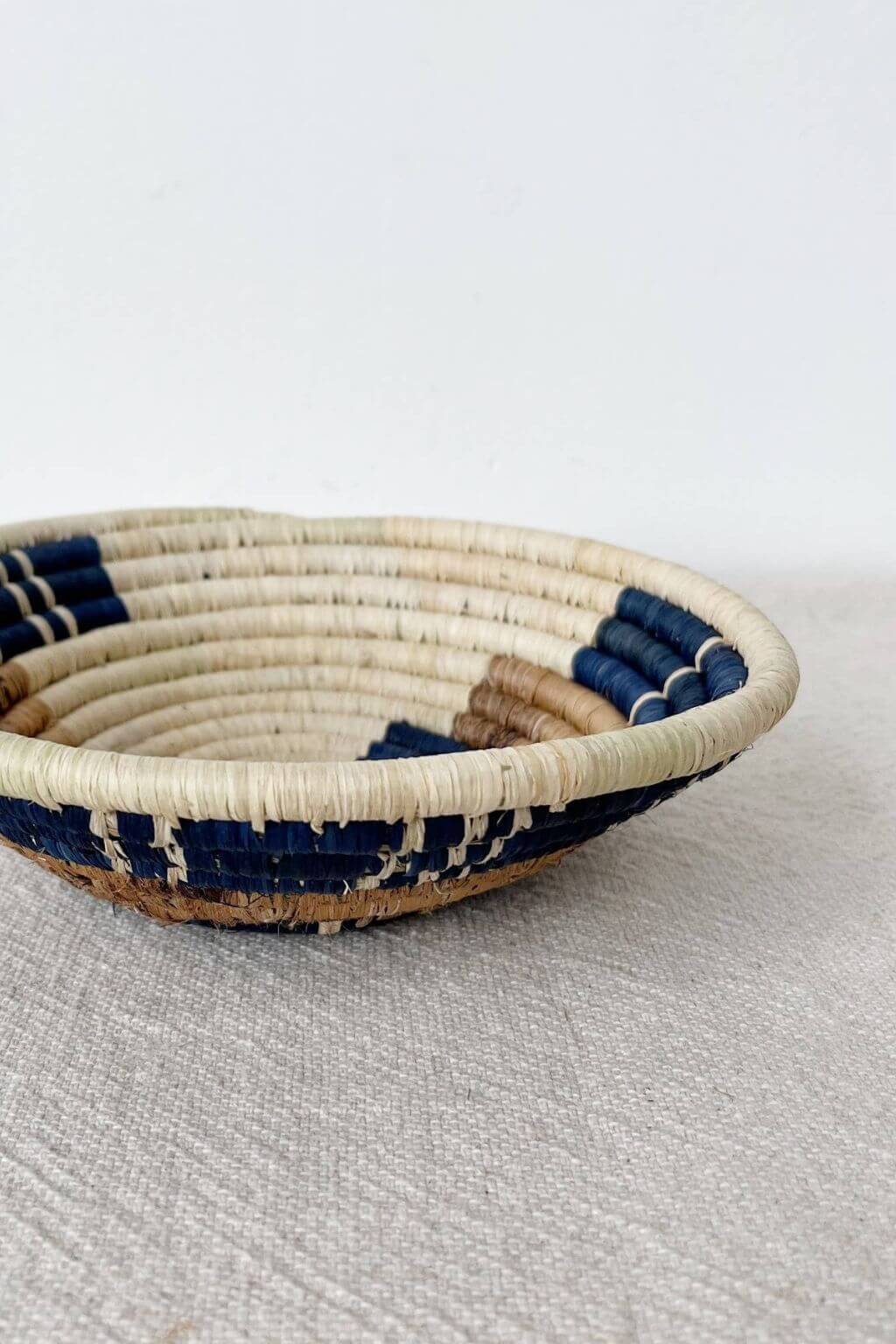 Handwoven Bamba bowl with blue and natural raffia pattern