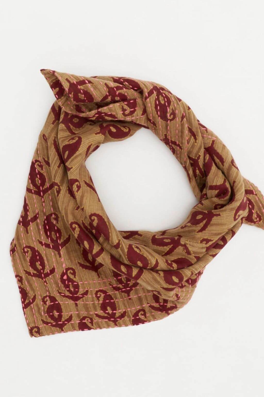 Brown scarf with red pattern on a white background
