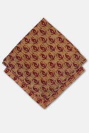 Hand-stitched cotton bandana with deep rust paisley motif on sun-warmed ochre ground