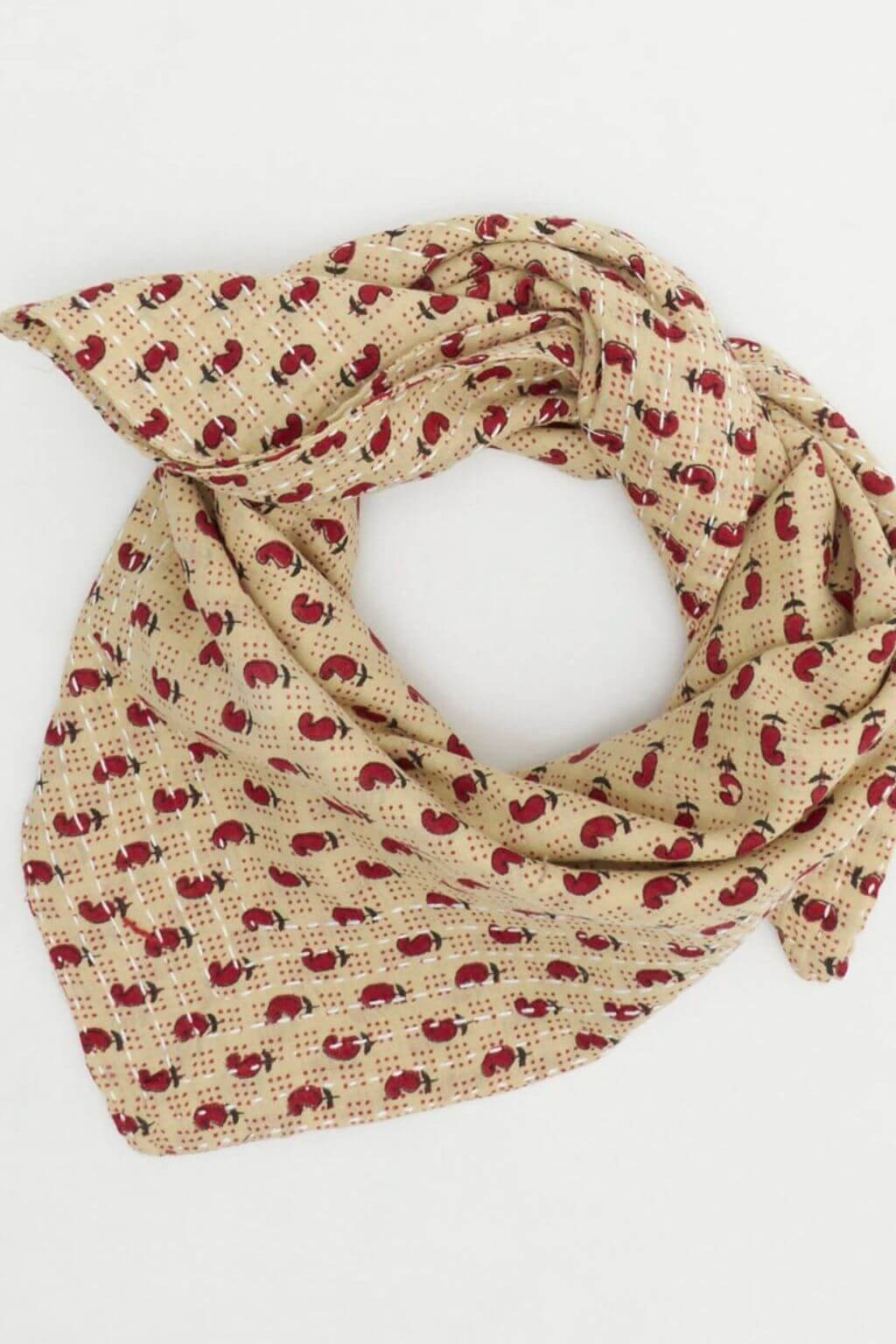 Beige scarf with red chilli pepper pattern on a white background