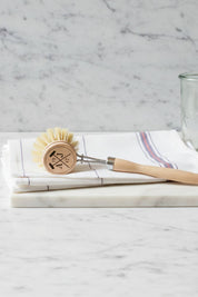 Wooden dish brush with natural bristles and ergonomic handle for everyday kitchen use