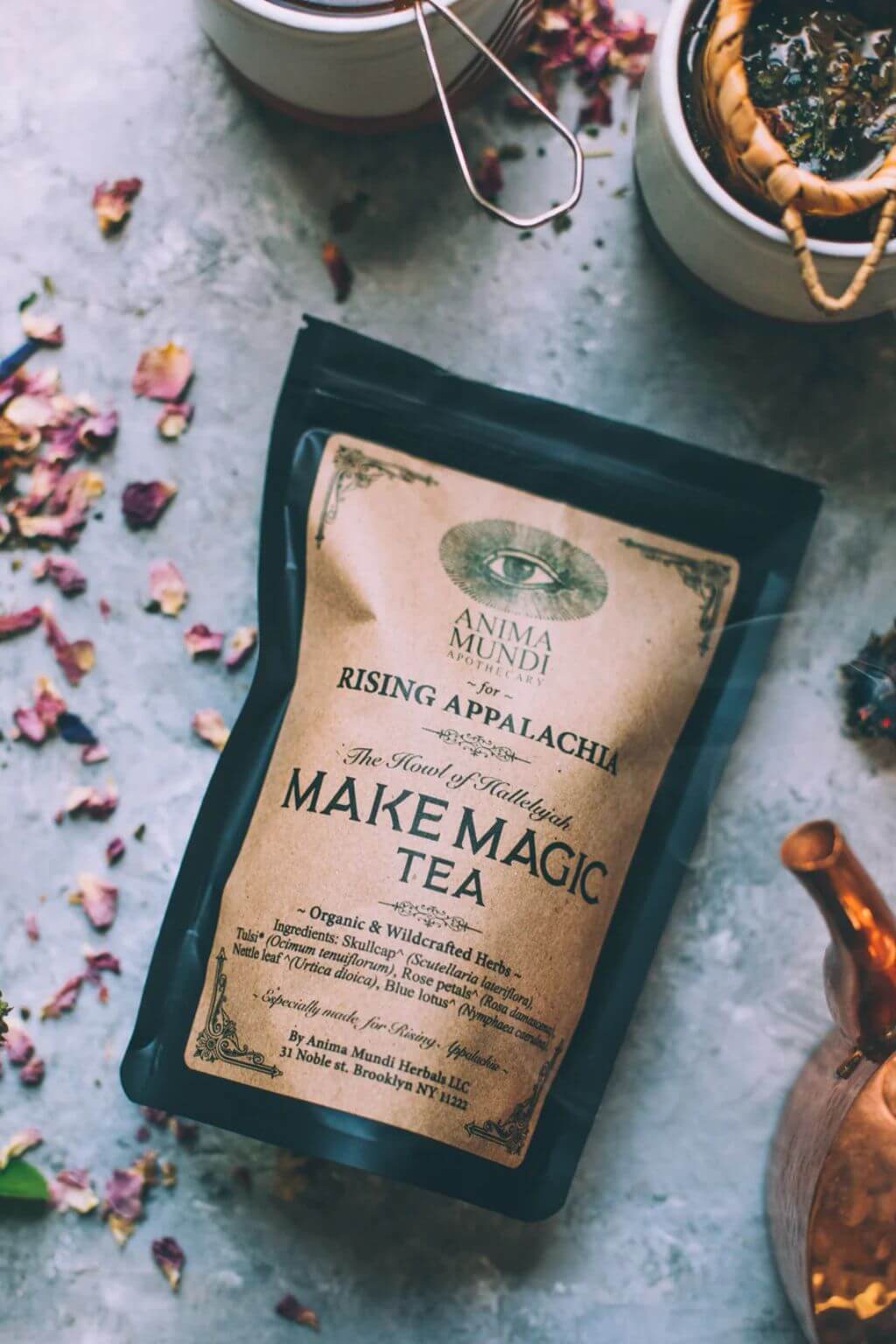 Tea package with 'Make Magic Tea' text on a textured surface with tea leaves.