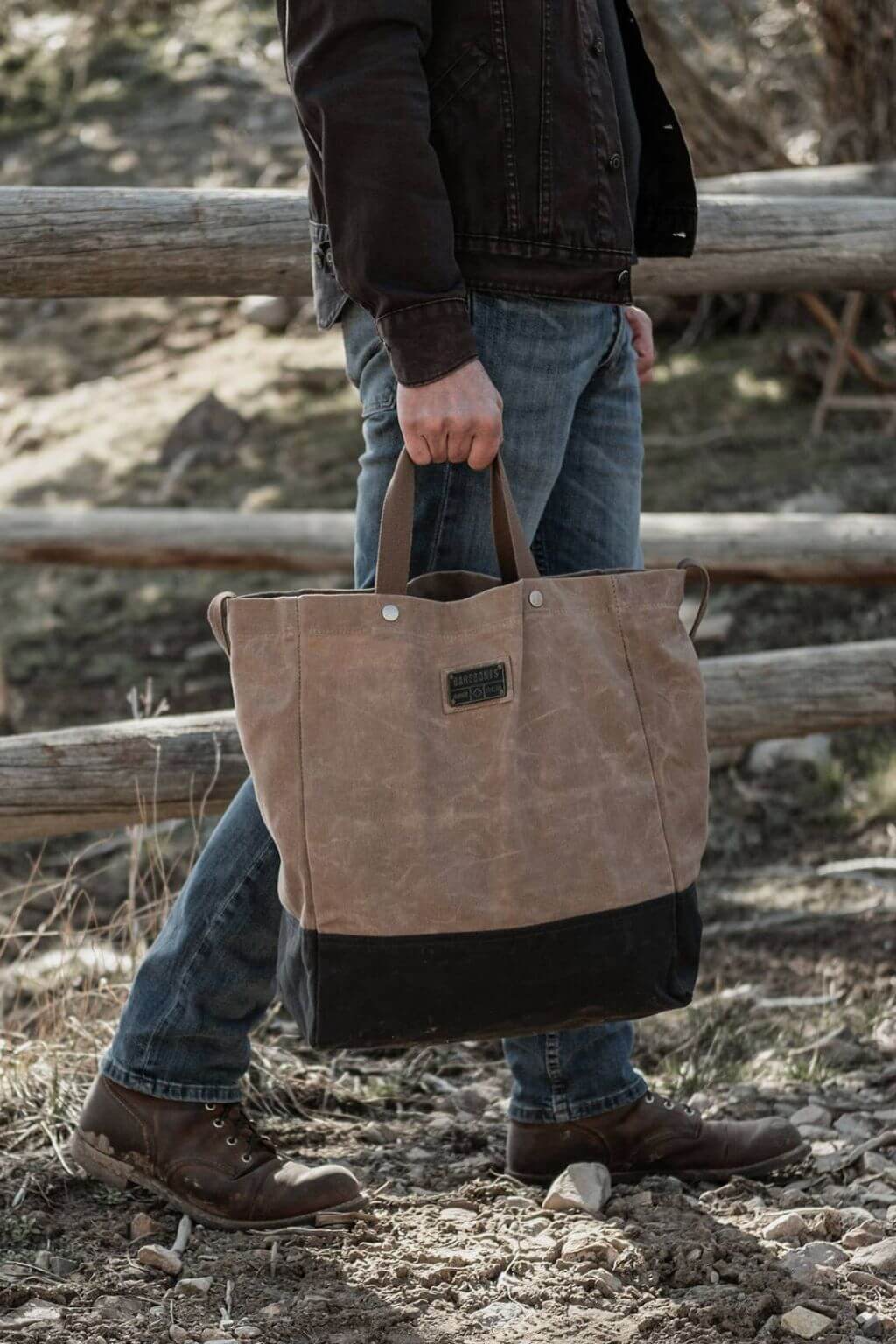 Man seated indoors with oversized waxed canvas tote bag