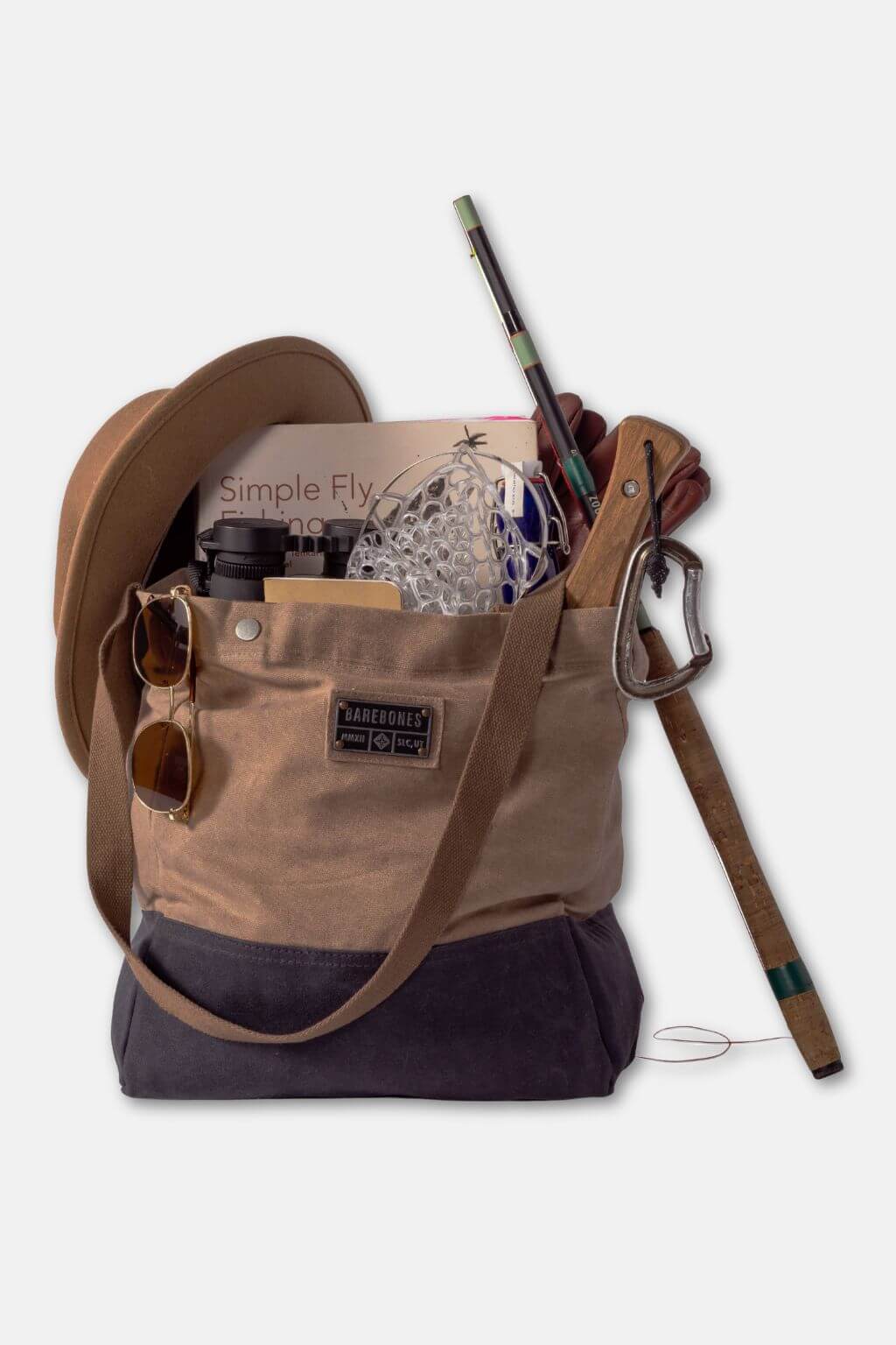 Brown and navy bag with fishing gear on a white background