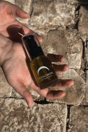 Moon Drops facial serum bottle in hand