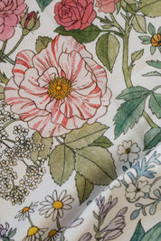 Detailed floral illustration on cotton tea towel featuring roses, daisies, and greenery