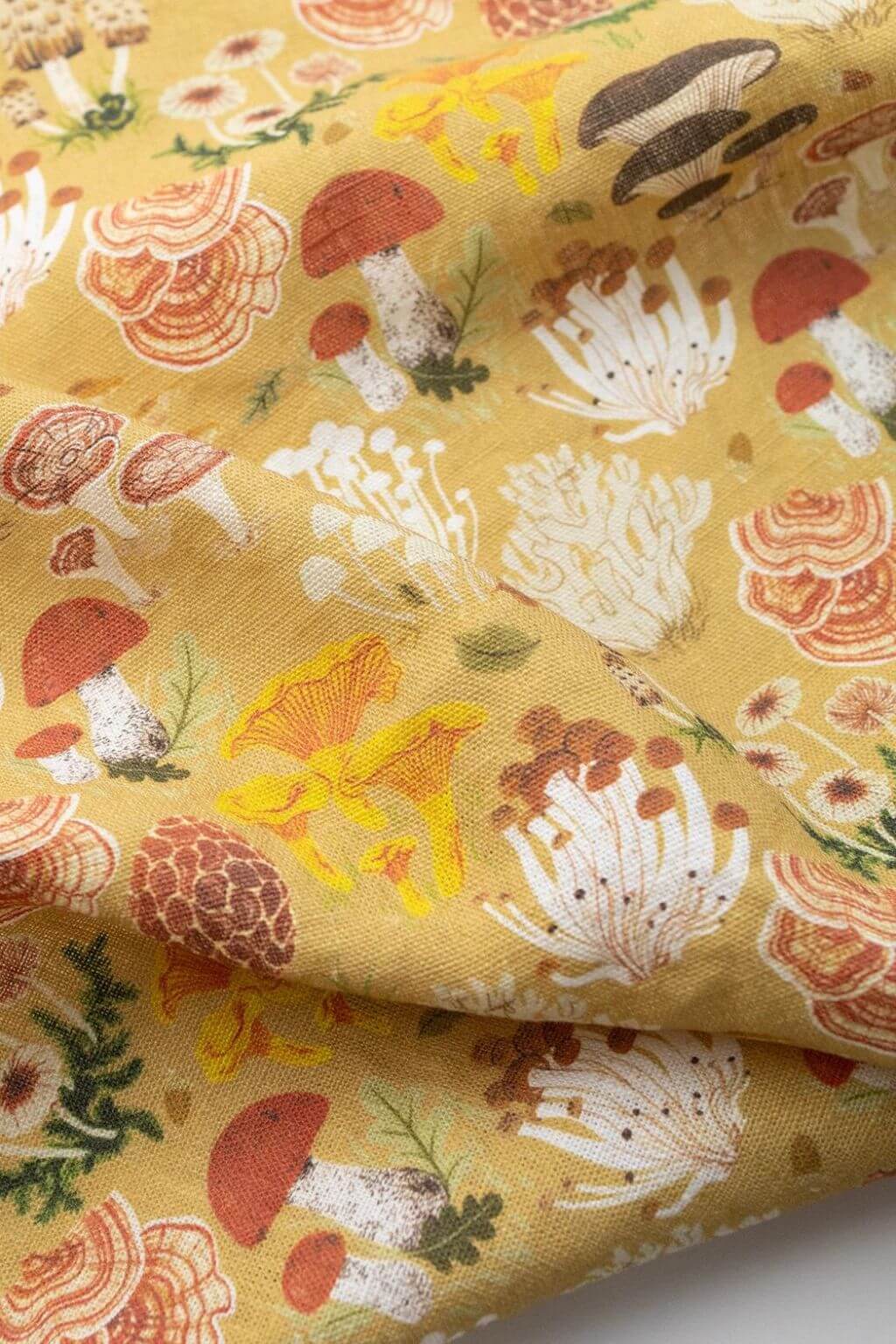 Close-up of earth-toned mushroom designs on Botanica Paper Co. Linen Tea Towel.