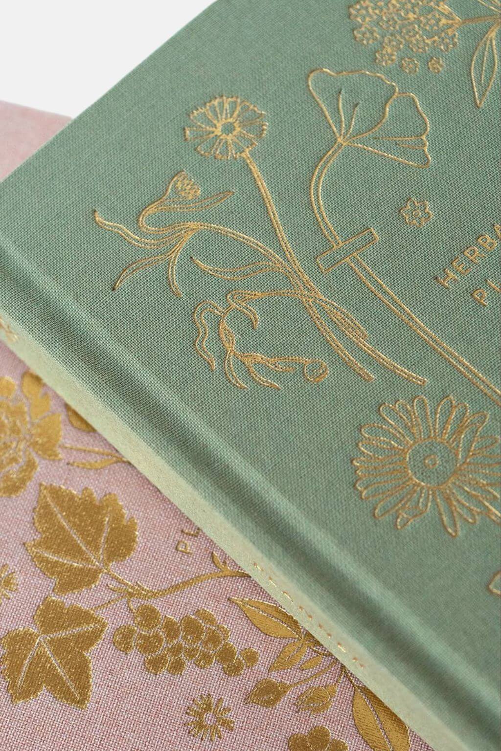 Close-up of gold foil floral embossing on the planner’s linen cover.