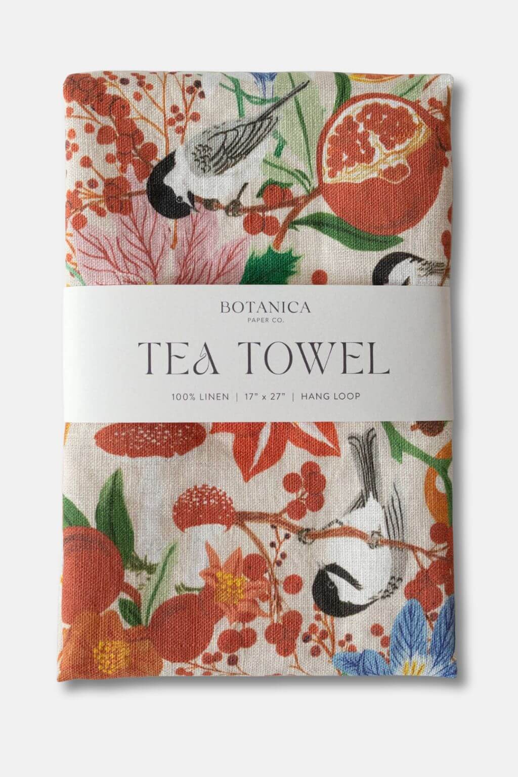 Folded Winter Floral Linen Tea Towel by Botanica Paper Co. featuring birds, berries, and pomegranates.