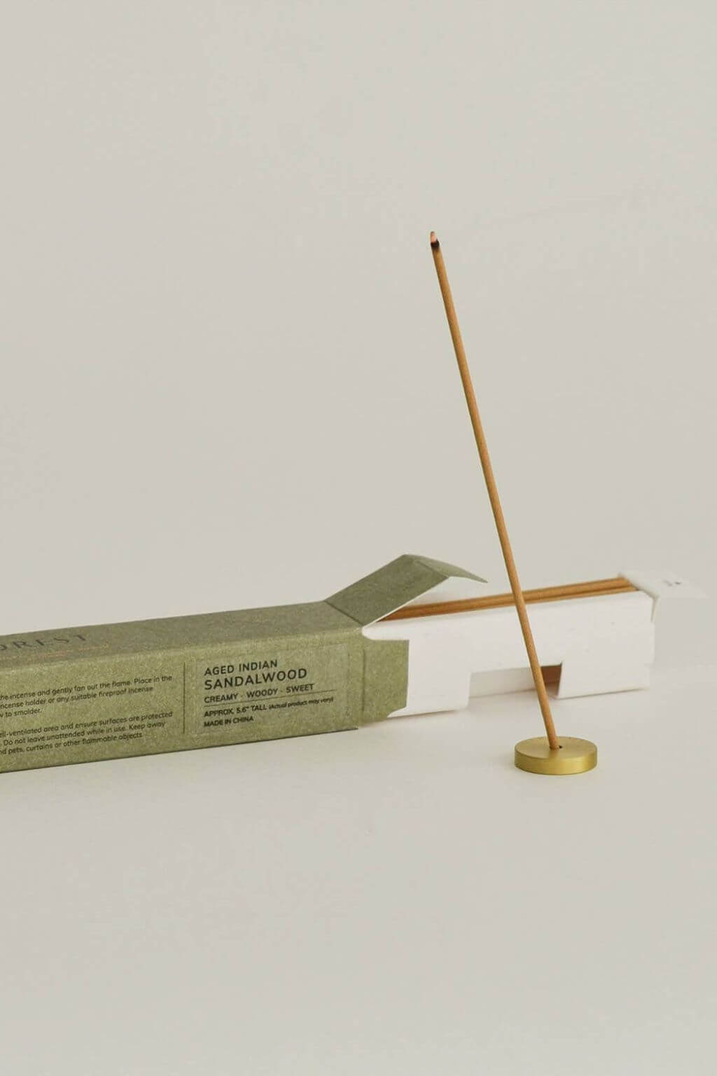 burning sandalwood incense stick with brass holder meditation incense