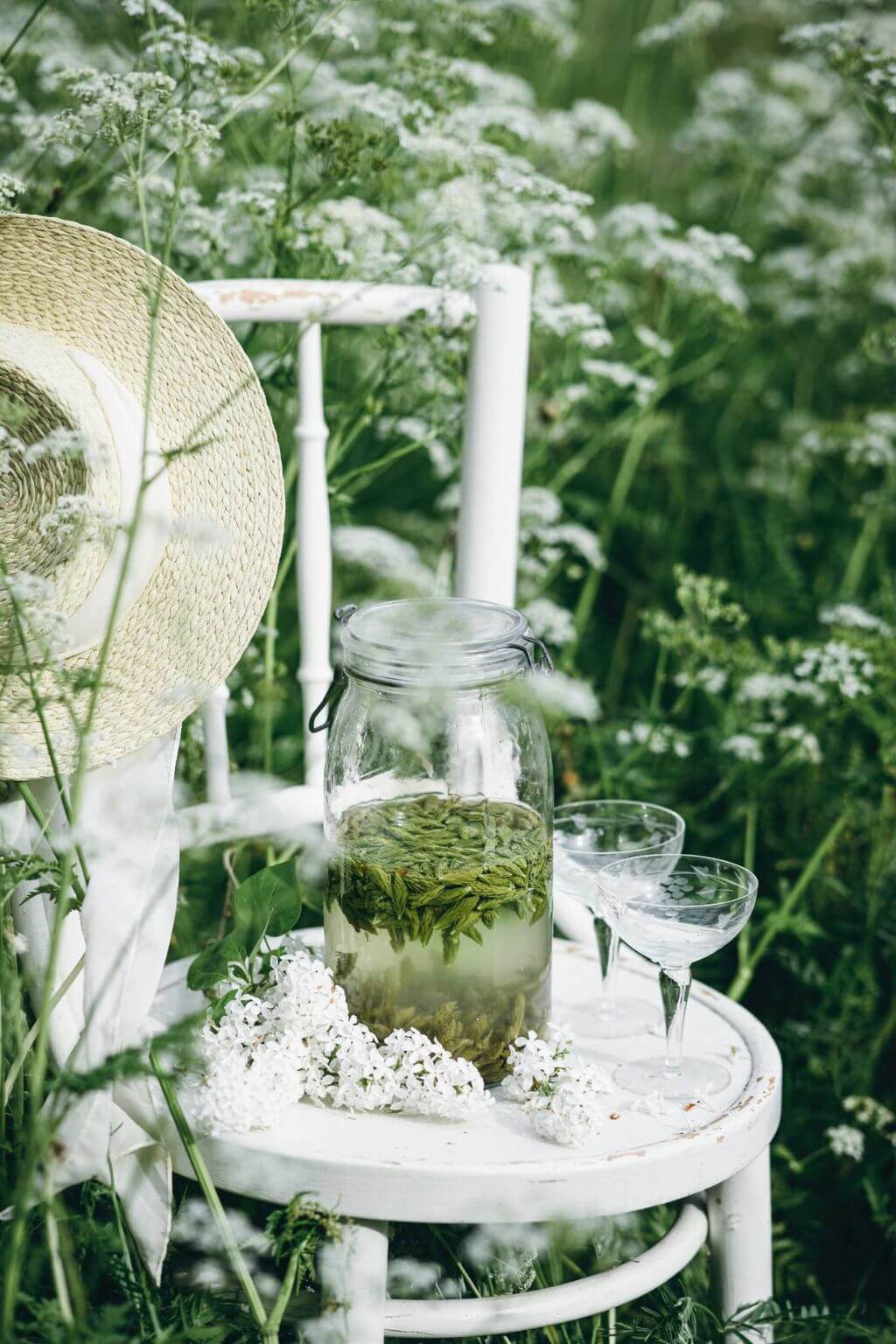Refreshing herbal summer beverage served in a vintage garden setting