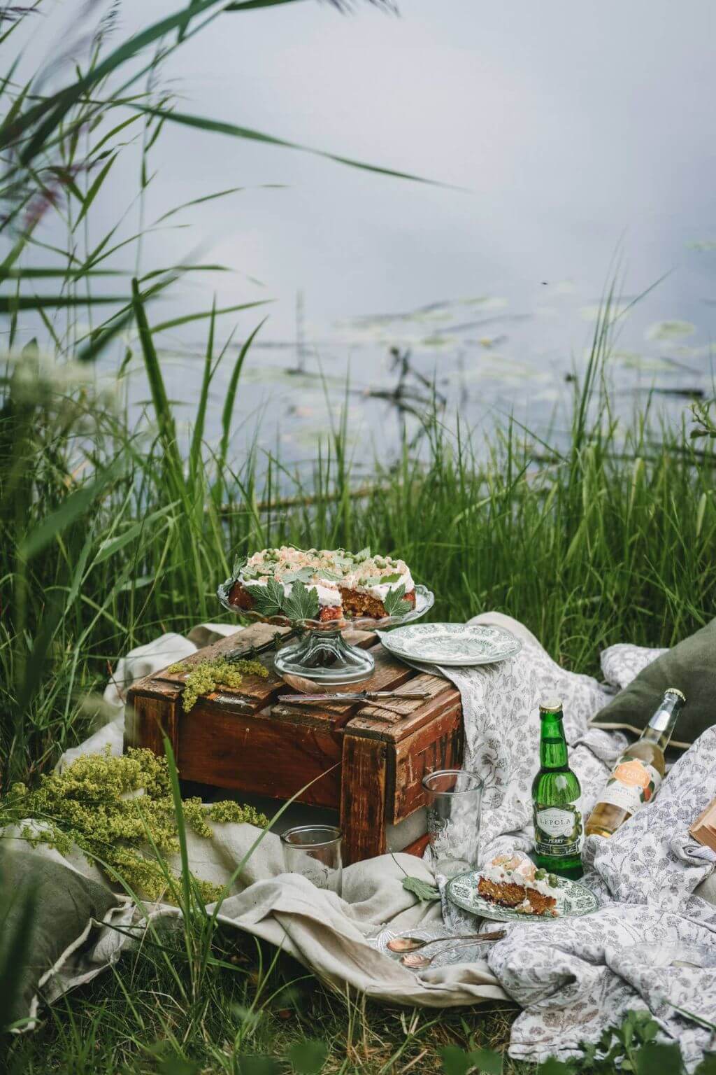 Scandinavian summer picnic beside lakeside grasses and wildflowers