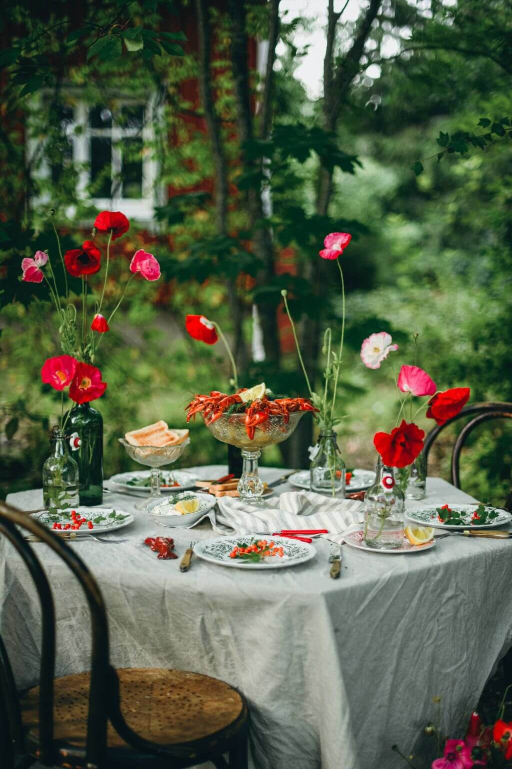 Elegant midsummer garden table adorned with flowers and seasonal dishes