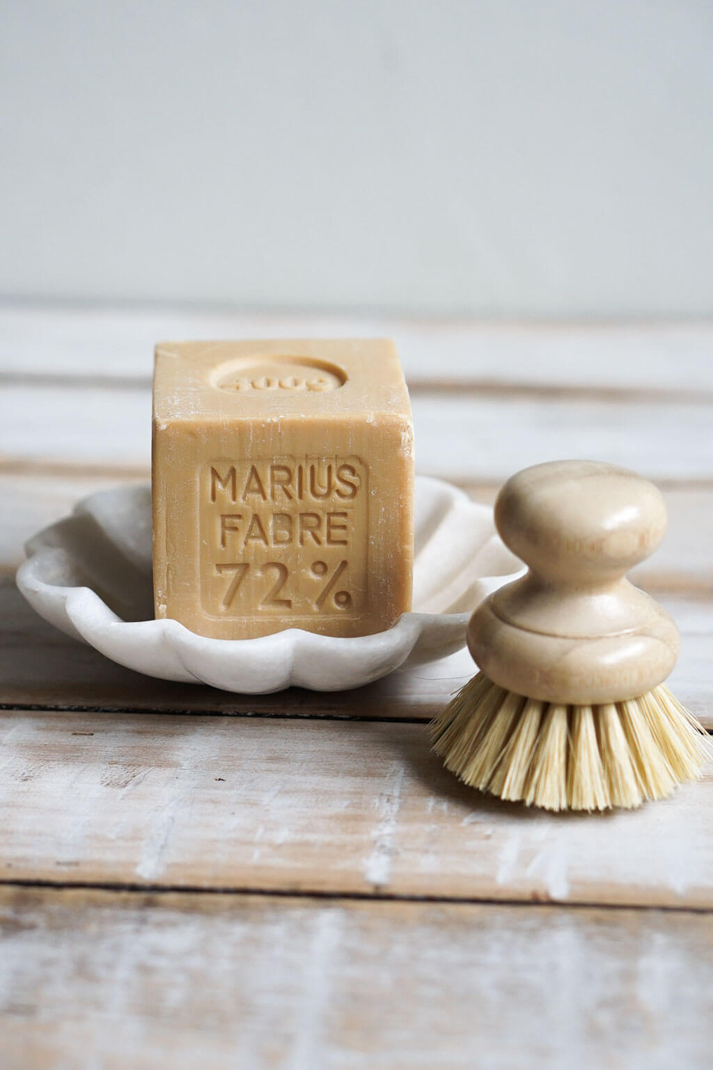 Marble soap dish holding olive oil soap and natural bristle brush