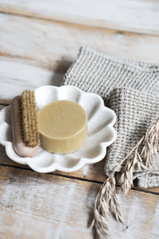 Marble fluted dish with round soap and neutral linen textiles