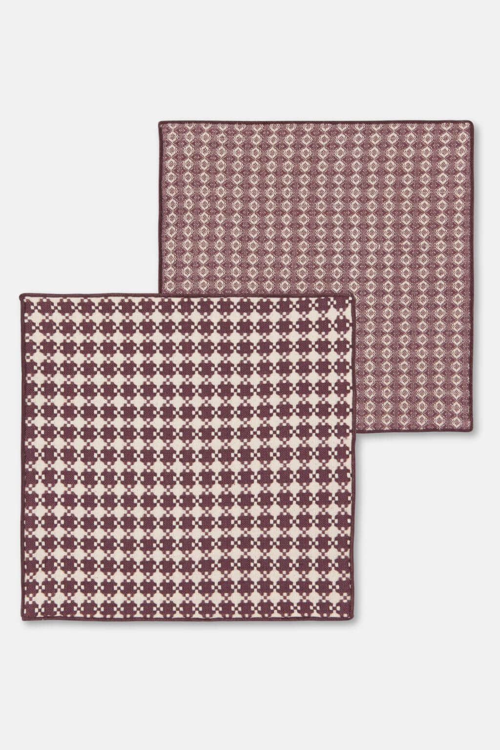 Two patterned Danica heirloom dishcloths on a white background