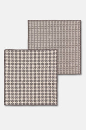 Flat-lay of two patterned woven dishcloths, part of a shadow gray cotton set.