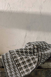 Shadow Gray Woven Dishcloths draped casually on a rustic wooden surface, highlighting their textured weave.