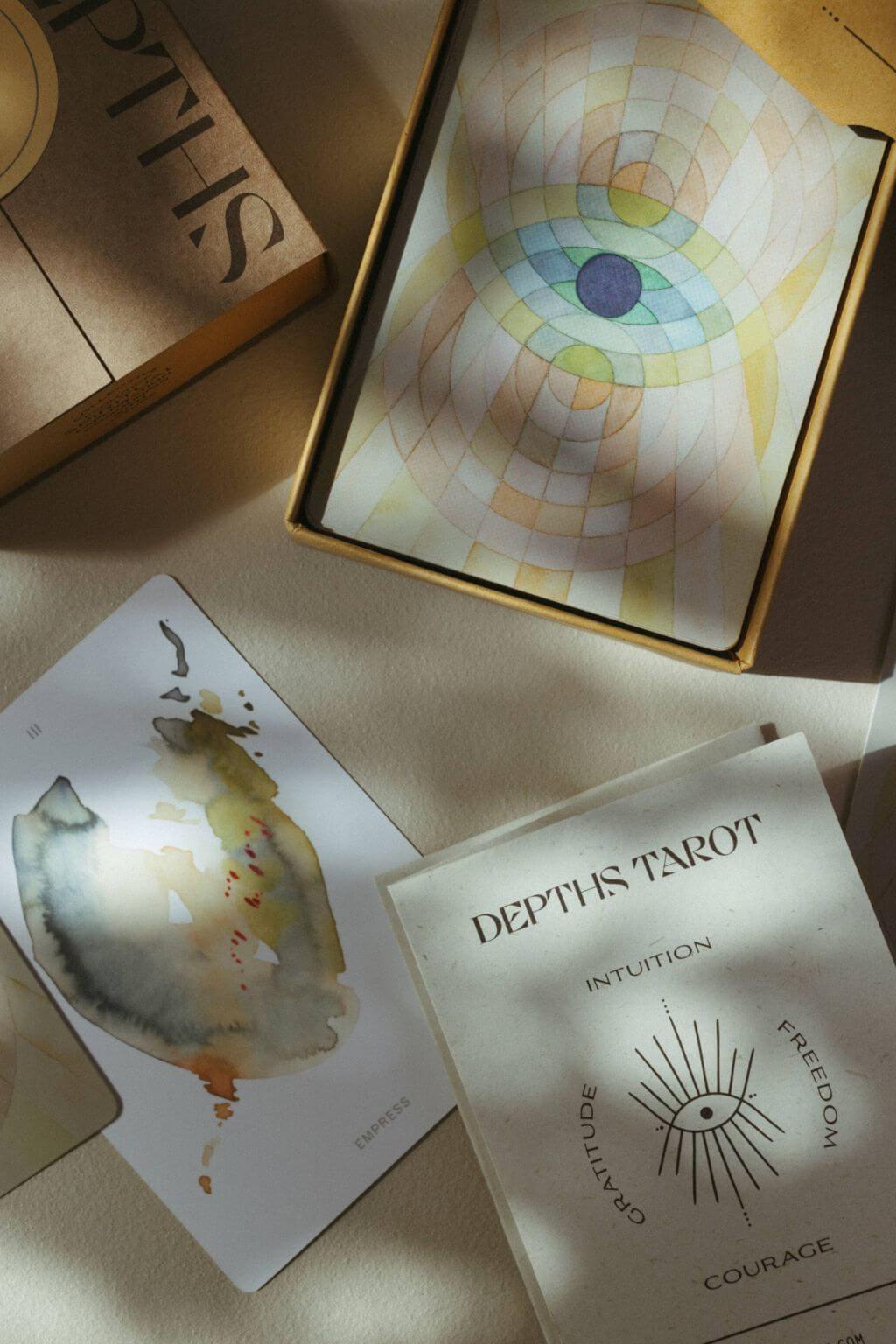 the depths tarot deck packaging and tarot cards with watercolor artwork