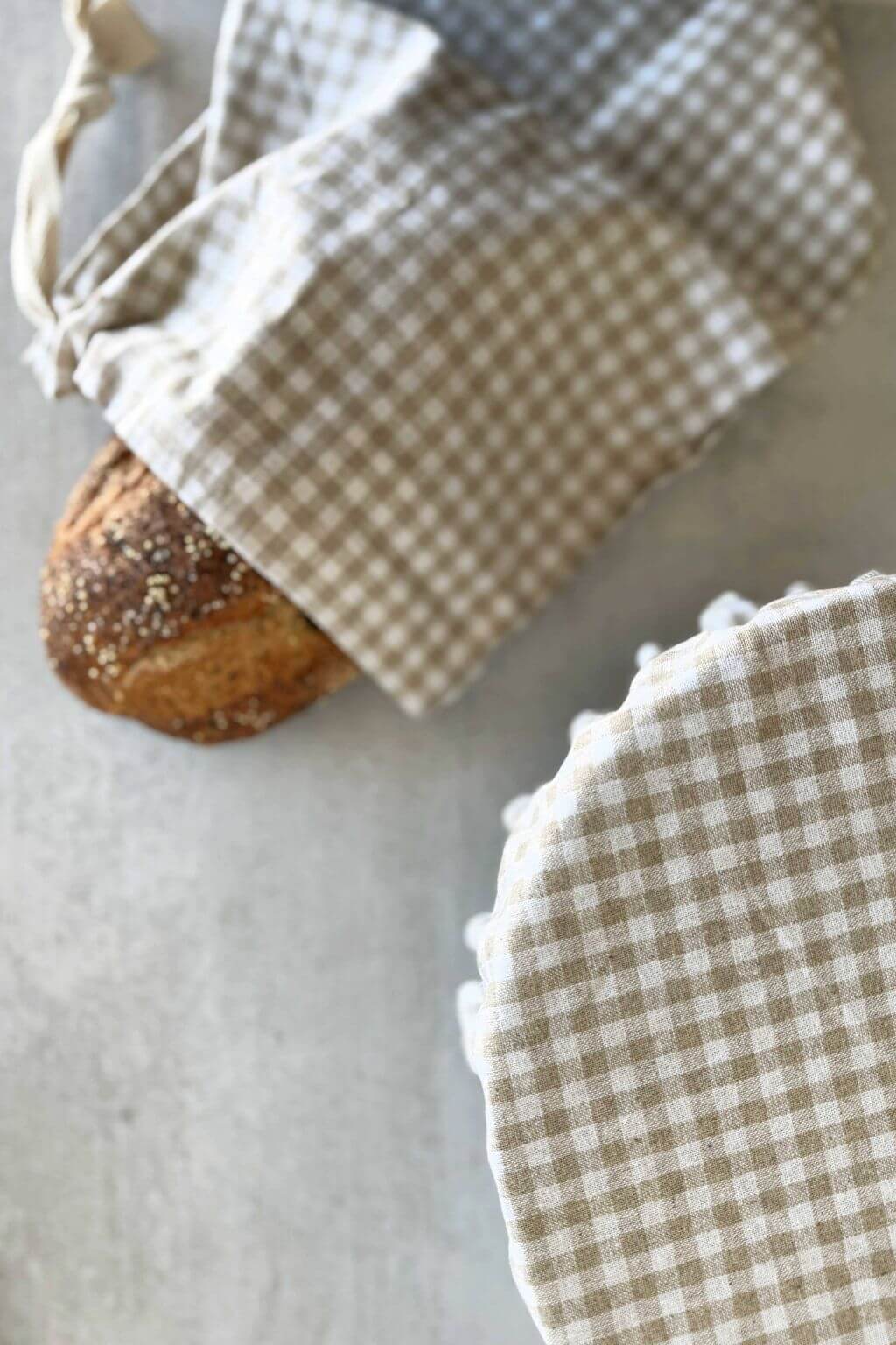 beige gingham reusable bowl cover with pom trim and matching bread bag