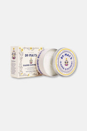 Open jar of Dr. Max’s diaper ointment with packaging showing natural ingredients